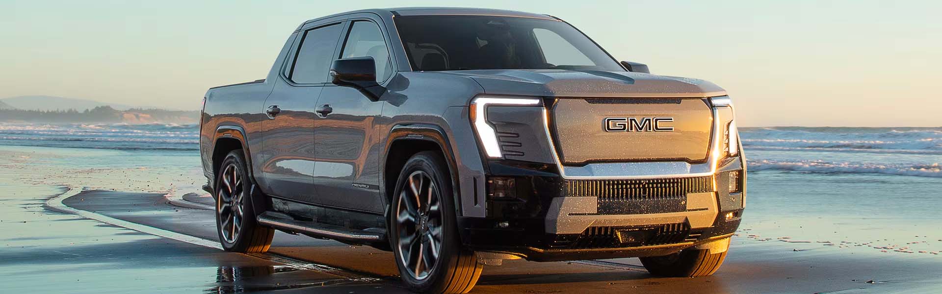 GMC Sierra_EV parked on the beach at sunset.